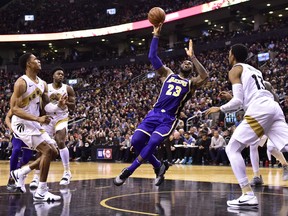 Los Angeles Lakers forward LeBron James (23) starts to fall to the court after being fouled by Toronto Raptors forward Malcolm Miller (13) during second half NBA basketball action in Toronto on Thursday, March 14, 2019. THE CANADIAN PRESS/