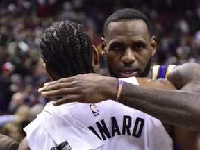 Los Angeles Lakers forward LeBron James (23) and Toronto Raptors forward Kawhi Leonard (2) greet each other after NBA basketball action in Toronto on Thursday, March 14, 2019. Leonard scored 25 points as the Toronto Raptors defeated familiar foe LeBron James and the Los Angeles Lakers 111-98 on Thursday night. THE CANADIAN PRESS/Frank Gunn