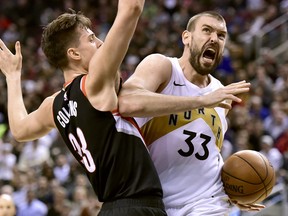 Raptors’ Marc Gasol (left) drives into the Blazers’ Zach Collins during the Raptors’ win on Friday.   Frank Gunn/The Canadian Press