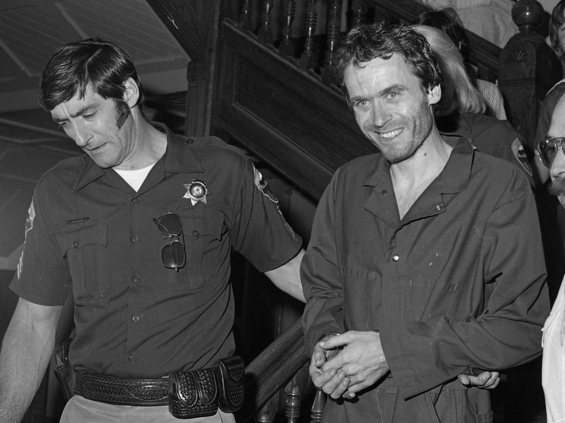 In this 1977 file photo, serial killer Ted Bundy, centre, is escorted out of court at the Pitkin County courthouse, Aspen, Colo. (Ross Dolan/Glenwood Springs Post Independent via AP)