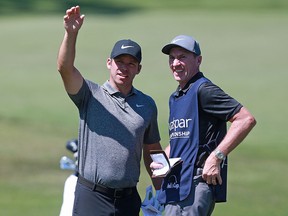 Paul Casey talks with his caddie, John McLaren, during the Valspar Championship on the Copperhead course at Innisbrook Golf Resort on March 23, 2019 in Palm Harbor, Florida. (Matt Sullivan/Getty Images)