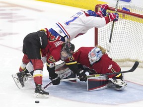 Les Canadiennes de Montreal's Hilary Knight collides with the Calgary goal under a challenge from Calgary Inferno's Kacey Bellamy and goaltender Alex Rigsby  yesterday. The Inferno beat Les Canadiennes to win the Clarkson Cup (The Canadian Press)