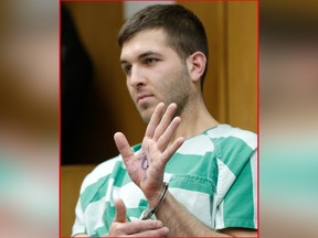 Anthony Comello displays writing on his hand during his extradition hearing in Toms River, N.J., Monday, March 18, 2019.