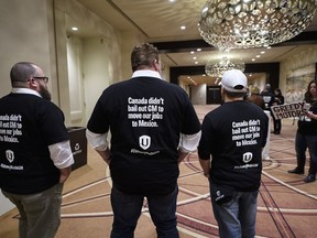 People who would be directly affected by the General Motors Oshawa plant closure stand in solidarity before Unifor National President Jerry Dias speaks during press conference asking for all Canadians and Americans to boycott all General Motors vehicles that are made in Mexico in Toronto on Friday, January 25, 2019.