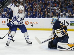 Buffalo Sabres goalie Carter Hutton, right, stops Toronto Maple Leafs forward John Tavares during the first period of an NHL hockey game Wednesday, March 20, 2019, in Buffalo, N.Y. (AP Photo/Jeffrey T. Barnes)