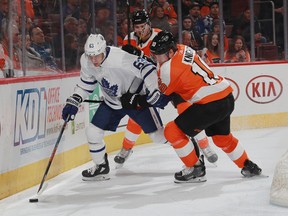 Maple Leafs’ Tyler Ennis (left) is checked by Flyers’ Travis Konecny on Wednesday night in Philadelphia. (GETTY IMAGES)