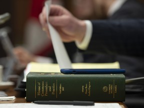 A copy of the House of Commons Procedure and Practice sits on the desk before the Standing Committee on Access to Information, Privacy and Ethics meets to discuss calling witnesses in Ottawa, Tuesday March 26, 2019. (THE CANADIAN PRESS/Adrian Wyld)