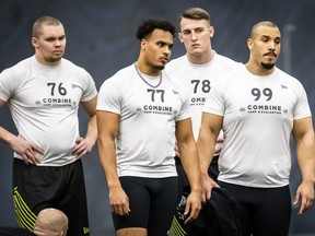 Defensive linemen Marc Anthony Hor of Germany, right, Johannes Zirngibl of Germany, second right, Valentinois Gnahoua of France, second left, and Okko Outinen of Finland, takes part in on field tests during the CFL combine in Toronto, Sunday March 24, 2019.