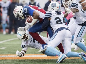 Montreal Alouettes' William Stanback (31) pushes through Toronto Argonauts defense during first half CFL football action in Montreal, Sunday, Oct. 28, 2018. THE CANADIAN PRESS/Graham Hughes