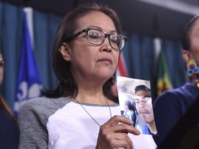 Debbie Baptiste, mother of Colten Boushie, holds a photo of her son during a press conference on Parliament Hill in Ottawa on February 14, 2018. A film examining the case of the young Indigenous man who was killed on a farm in rural Saskatchewan will open this year's Hot Docs festival in Toronto. THE CANADIAN PRESS/Justin Tang