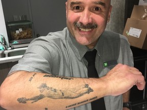 Steve Medeiros shows off his tattoo of Roy “Doc” Halladay