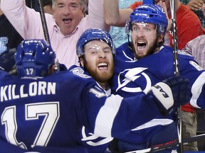 TAMPA, FL - MAY 20: Nikita Kucherov #86 of the Tampa Bay Lightning celebrates with his teammate Nikita Nesterov #89 and Alex Killorn #17 after scoring the game winning goal in overtime to defeat the New York Rangers 6 to 5 in Game Three of the Eastern Conference Finals during the 2015 NHL Stanley Cup Playoffs at Amalie Arena on May 20, 2015 in Tampa, Florida. (Photo by Bruce Bennett/Getty Images)