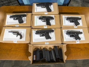 Police display seized firearms at Toronto Police Service headquarters in Toronto on Wednesday, January 25, 2017. (Ernest Doroszuk/Toronto Sun)