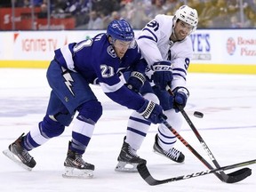 Toronto Maple Leafs centre John Tavares and Tampa Bay Lightning centre Brayden Point battle for the puck during third period NHL hockey action in Toronto on Monday, March 11, 2019.