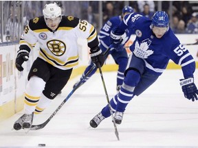 Toronto Maple Leafs defenceman Andreas Borgman (55) battles for the puck along the boards with Boston Bruins centre Noel Acciari (55) during first period NHL hockey action in Toronto on Friday, November 10, 2017. The Maple Leafs have signed defenceman Borgman to a one-year, two-way contract extension.THE CANADIAN PRESS/Nathan Denette ORG XMIT: CPT121