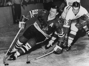 Ted Lindsay, right, chases Stan Mikita of the Blackhawks during a Feb. 24, 1965 NHL game in Chicago.