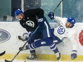 Maple Leafs defenceman Justin Holl (left) hits Toronto Maple Leafs Patrick Marleau during a practice earlier this season. (Ernest Doroszuk/Toronto Sun)