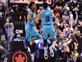 Charlotte Hornets guard Jeremy Lamb (3) celebrates his game-winning basket against the Raptors with teammate Devonte' Graham on Sunday night at Scotiabank Arena. (Frank Gunn/The Canadian Press)