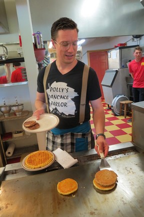 Chris Côte, great-grandson of Polly’s Pancake Parlor, Sugar Hill, N.H. founder, flips pancakes on the grill. (Ian Robertson)