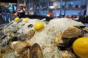 Oysters on ice as staff fill drink orders in Row 54, a restaurant and bar, 5 Portwalk Place at Hanover St. (Ian Robertson)