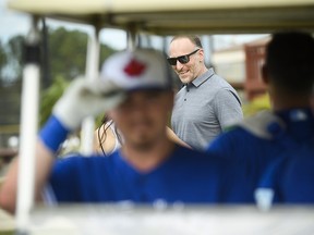 Mark Shapiro, centre, president and CEO of the Blue Jays, is shown through a golf cart during spring training in Dunedin, Fla., on Wednesday, February 20, 2019. (THE CANADIAN PRESS/Nathan Denette)