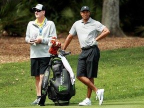 Tiger Woods (right) and caddie Joe LaCava (left) look on during a practice round for The Players Championship on The Stadium Course at TPC Sawgrass in Ponte Vedra Beach, Fla., on Wednesday, March 13, 2019.