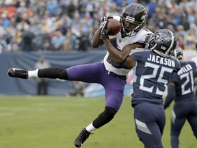 In this Oct. 14, 2018, file photo, Ravens wide receiver John Brown catches a pass as Titans' Adoree' Jackson (25) defends during first half NFL action in Nashville, Tenn.