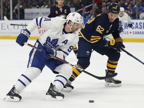 Sabres defenceman Brandon Montour pressures Maple Leafs forward John Travares on Wednesday night in Buffalo. (Jeffrey T. Barnes/The Associated Press)