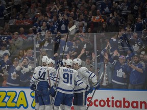 The Maple Leafs and their travelling fans celebrate Toronto's third goal at Rogers Place in Edmonton on March 9, 2018. (Shaughn Butts / Postmedia Network)
