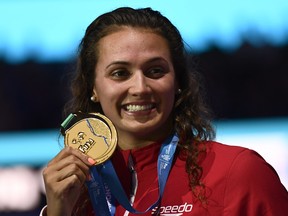 Canada's Kylie Jacqueline Masse celebrates on the podium after the women's 100-metre backstroke final during the swimming competition at the 2017 FINA World Championships in Budapest, on July 25, 2017. (CHRISTOPHE SIMON/AFP/Getty Images)