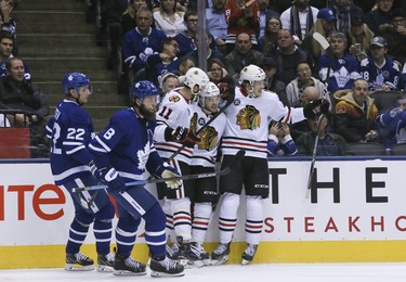 Blackhawks players celebrate a goal against the Maple Leafs in the second period during NHL action in Toronto on Wednesday, March 13, 2019.