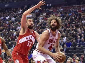 Chicago Bulls centre Robin Lopez (42) moves towards the basket as Toronto Raptors centre Marc Gasol (33) defends during first half NBA basketball action in Toronto on March 26, 2019. (FRANK GUNN/The Canadian Press)