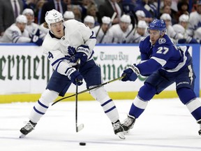 Toronto Maple Leafs right wing Kasperi Kapanen (24) passes off in front of Tampa Bay Lightning defenseman Ryan McDonagh (27) during the first period of an NHL hockey game, Thursday, Jan. 17, 2019, in Tampa, Fla. (AP Photo/Chris O'Meara)