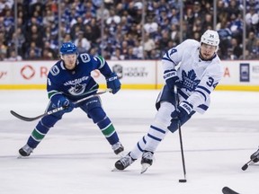 Leafs centre skates past Canucks winger Brock Boeser  on Wednesday. THE CANADIAN PRESS