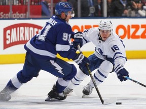 Maple Leafs forward Mitchell Marner (right) puts pressure on Lightning forward Steven Stamkos (left) during NHL action in Toronto on Monday, March 11, 2019.
