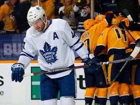Maple Leafs’ Morgan Rielly skates away as the Predators celebrate a first-period goal on Tuesday night at Bridgestone Arena in Nashville. (GETTY IMAGES)