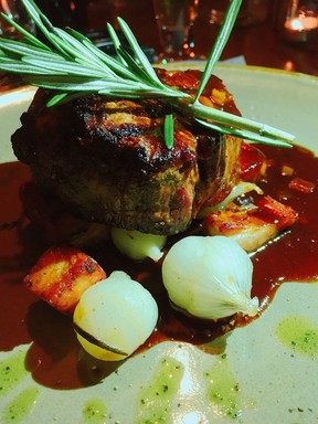 The tender 7-ounce filet mignon is bathed in red wine reduction and served with truffle mac and cheese at Elliott’s on Linden in Pinehurst, N.C. (KEVIN HANN)