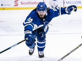 Maple Leafs centre Nic Petan reaches for the puck during NHL action against the Sabres in Toronto on March 2, 2019.