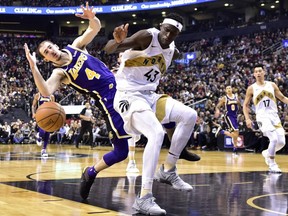 Raptors forward Pascal Siakam (right) and Lakers guard Alex Caruso (left) collide during second half NBA action in Toronto on Thursday, March 14, 2019.