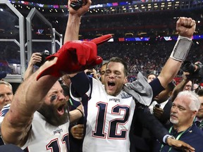 In this Sunday, Feb. 3, 2019, photo New England Patriots' Julian Edelman, left, and Tom Brady celebrate after the NFL Super Bowl LIII football game against the Los Angeles Rams in Atlanta.  (Curtis Compton/Atlanta Journal-Constitution via AP)