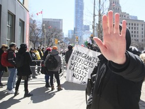 Pro-Immigration groups and members of PEGIDA are separated by fences and police on University Avenue and Armoury Street on Saturday, March 23, 2019 in Toronto. (Veronica Henri/Toronto Sun/Postmedia Network)