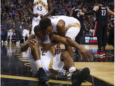 Toronto Raptors Kawhi Leonard SF (2) gets a hug and lift by teammate Kyle Lowry after scoring and being fouled In the fourth quarter in Toronto, Ont. on Friday March 1, 2019. Jack Boland/Toronto Sun/Postmedia Network