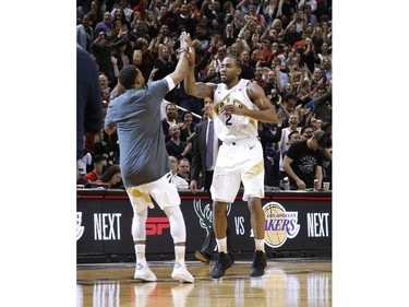 Toronto Raptors Kawhi Leonard SF (2) is pumped after draining  winning shot at the end of the fourth quarter and high fives teammate Norman Powell  in Toronto, Ont. on Friday March 1, 2019. Jack Boland/Toronto Sun/Postmedia Network