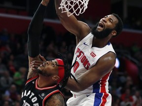 Detroit Pistons centre Andre Drummond  dunks on Toronto Raptors forward Eric Moreland in Detroit on Sunday. (AP)