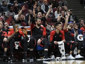 The Toronto Raptors bench celebrates after Norman Powell makes a 3-point shot during the final minutes of the second half of an NBA basketball game against the Chicago Bulls Saturday, March 30, 2019, in Chicago. Toronto won 124-101. (AP Photo)