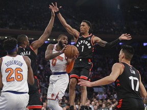 Toronto Raptors' Patrick McCaw (1) and Serge Ibaka defend against New York Knicks' Kadeem Allen (0) during the second half of an NBA basketball game Thursday, March 28, 2019, in New York. The Raptors won 117-92. (AP Photo/Frank Franklin II)