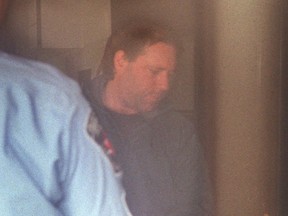 Robert Glenn Badgerow enters Provincial Court in Hamilton.