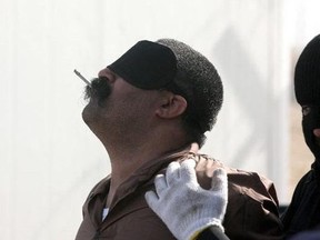 A doomed man in Saudi Arabia enjoys a final smoke before his beheading.