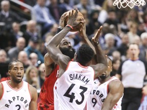 Raptors Pascal Siakam and Rockets James Harden battle for the ball on Tuesday. VERONICA HENRI/TORONTO SUN