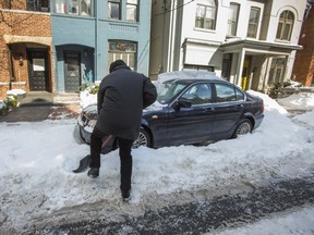A resident digs his car out of the snow on Collier St., near Church St. and Bloor St. E. in Toronto, Ont. on Friday March 1, 2019. (Ernest Doroszuk/Toronto Sun/Postmedia)